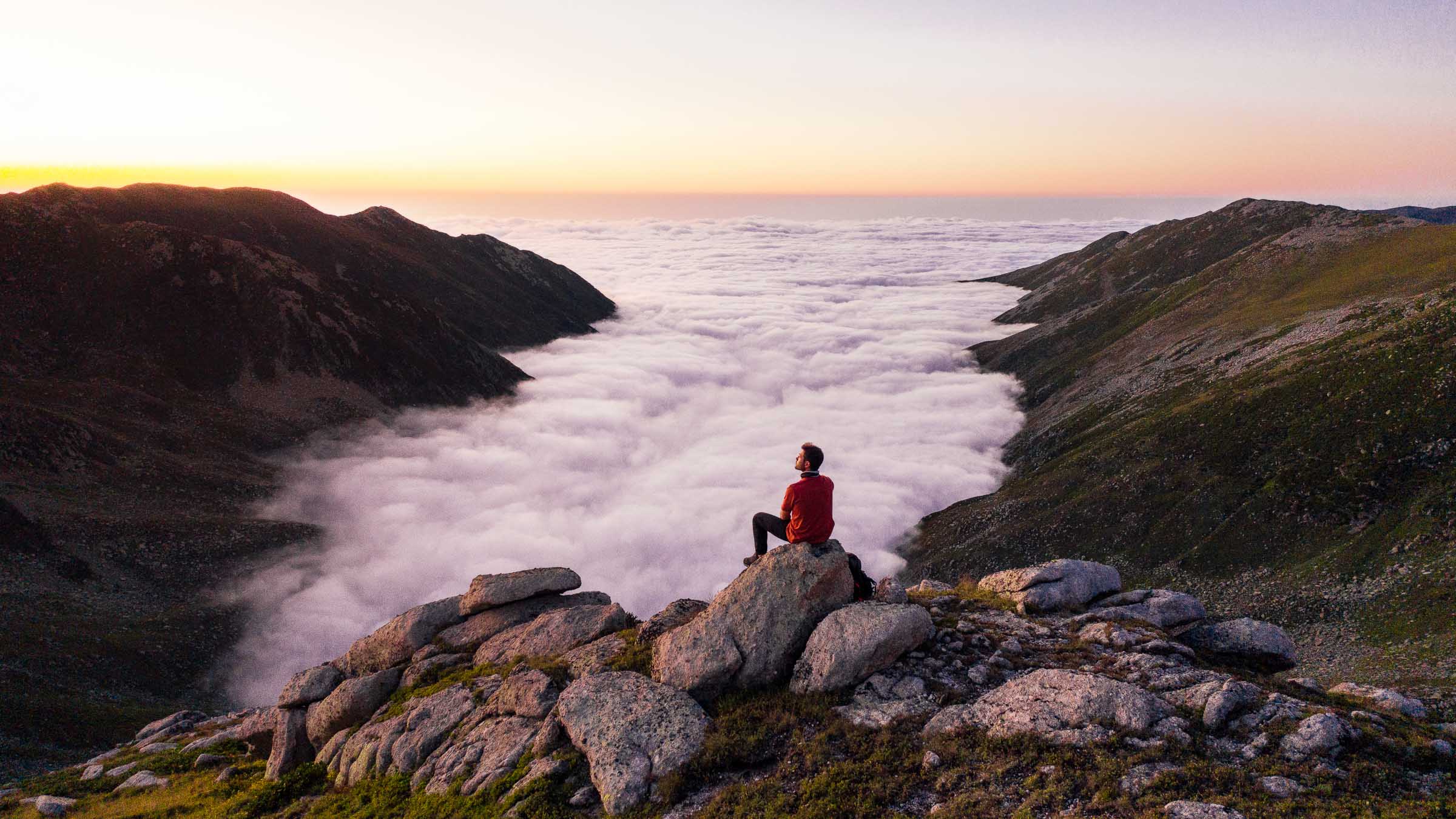 Hiker above a sea of cloud in the Kaçkar Mountains