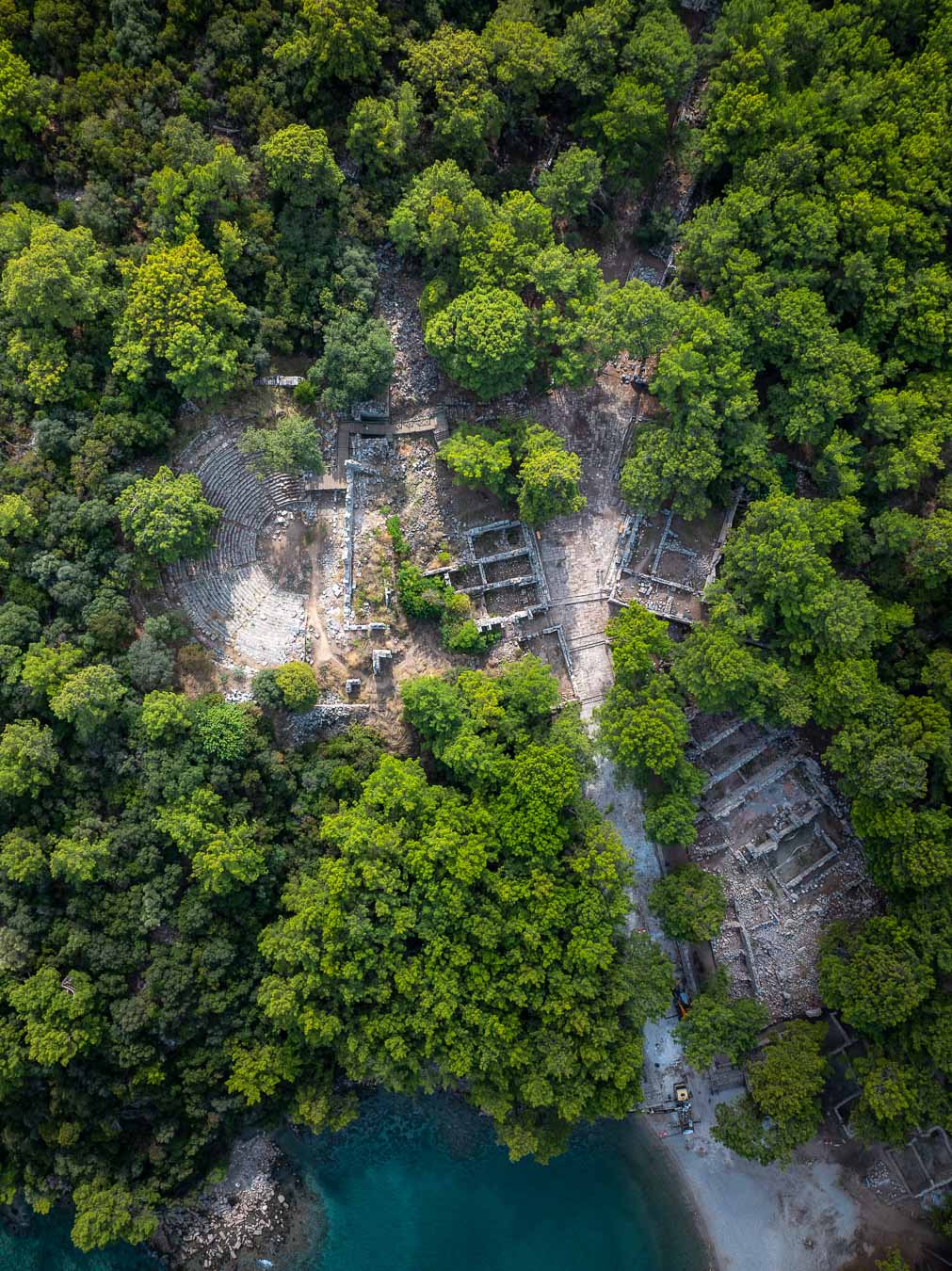 Aerial view of the theatre and ruins of Phaselis among pines