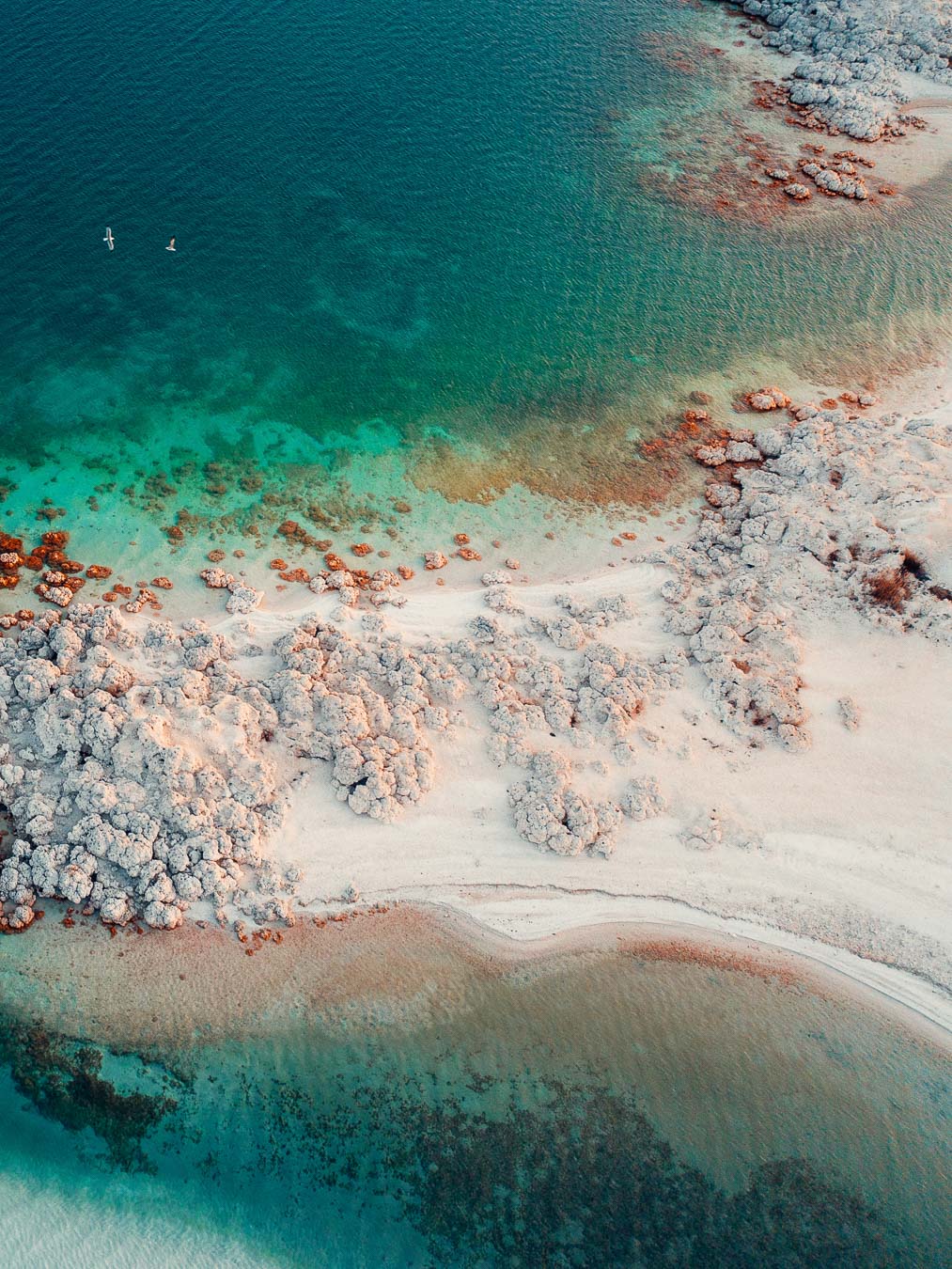 White carbonate rocks along the turquoise shore of Salda Lake in Burdur, seen from above