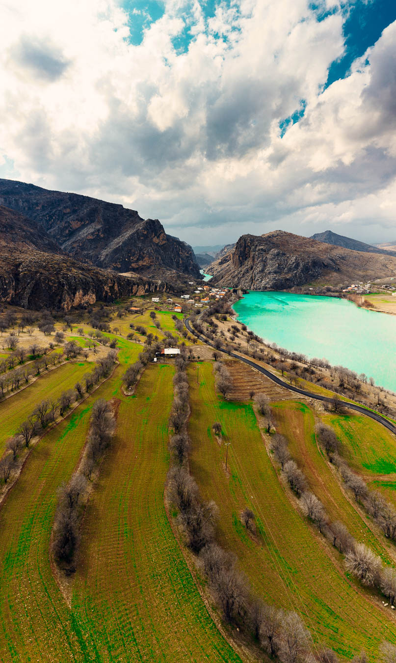 Aerial view of the turquoise Karasu river, the upper Euphrates, winding between dry hills near İliç, Erzincan