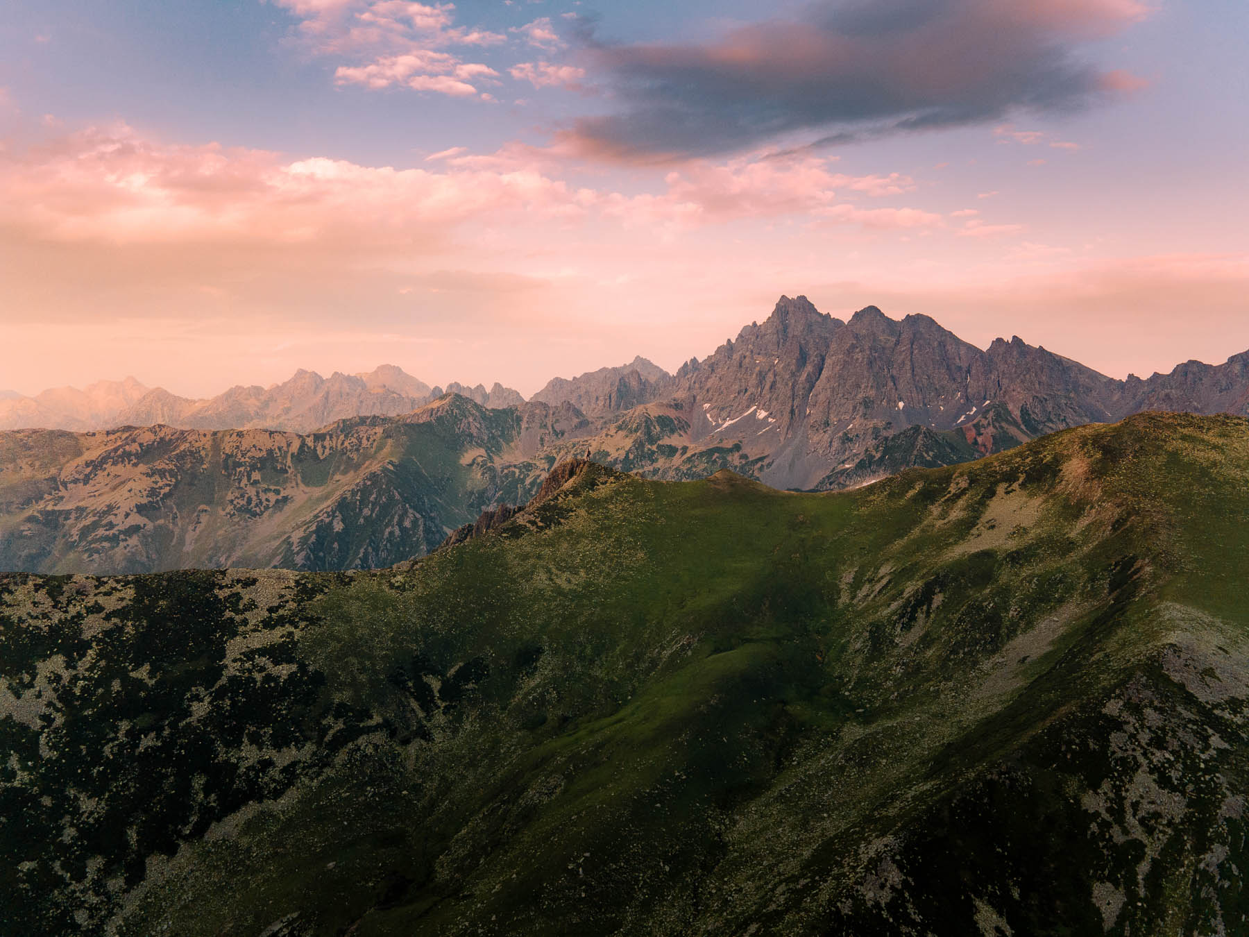 The jagged peaks of the Kaçkar range above green slopes at sunset