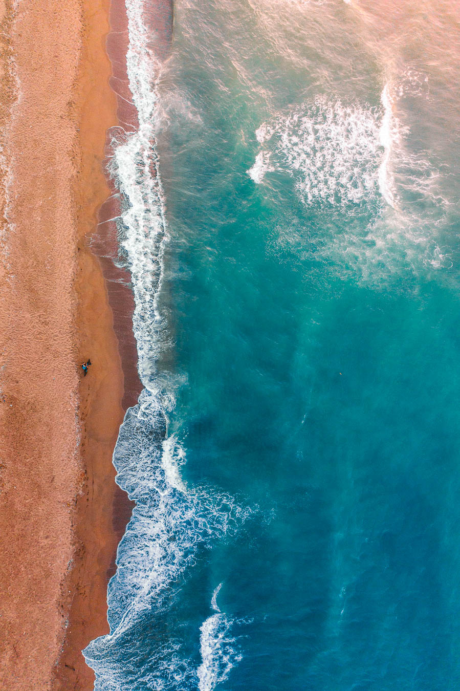 Waves breaking on a long sandy beach at Karasu, seen from above