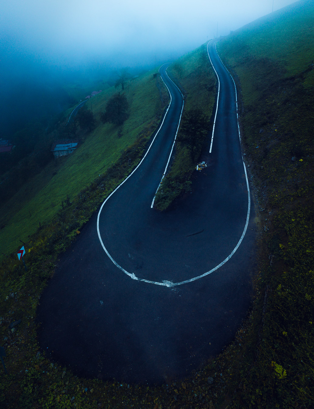 A hairpin bend on a misty mountain road in Çaykara